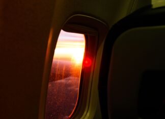 photography of airplane window during dusk
