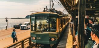 Fukuoka Without the Tokyo Crush: Why Kyushu Is the Smarter Japan Trip This Spring scenic train arrival at japanese coastal station