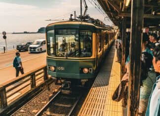 scenic train arrival at japanese coastal station