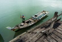 Belitung Island 2026: The Direct-Flight Beach Escape Replacing Another Bali fisherman in traditional boat on indonesian waters