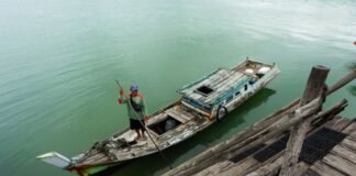 Belitung Island 2026: The Direct-Flight Beach Escape Replacing Another Bali fisherman in traditional boat on indonesian waters