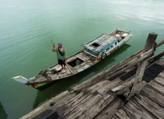 fisherman in traditional boat on indonesian waters