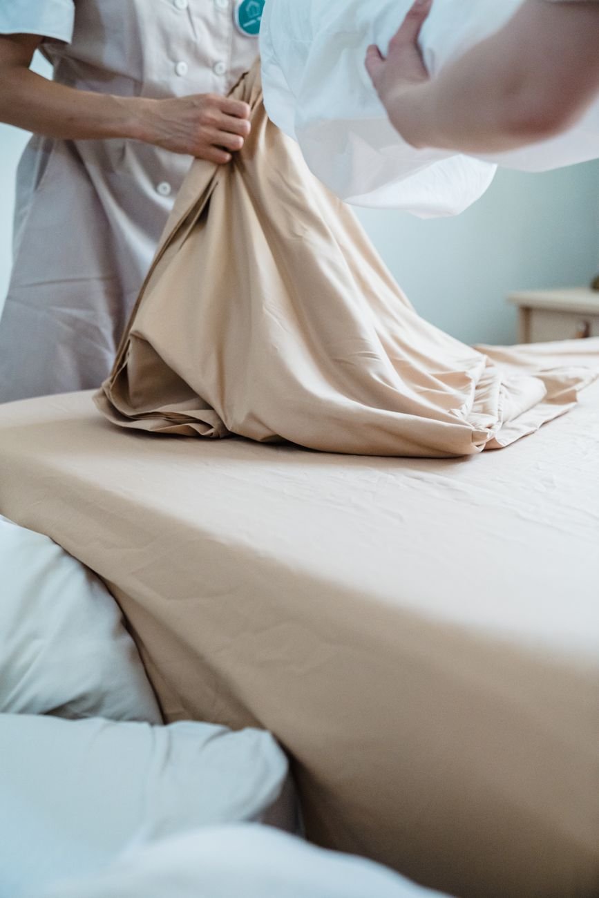 Qantas Grounds Dreamliner in Rome After Bed Bugs on Perth Flight: How to Avoid Them 1 close up of housekeepers changing bedding in hotel